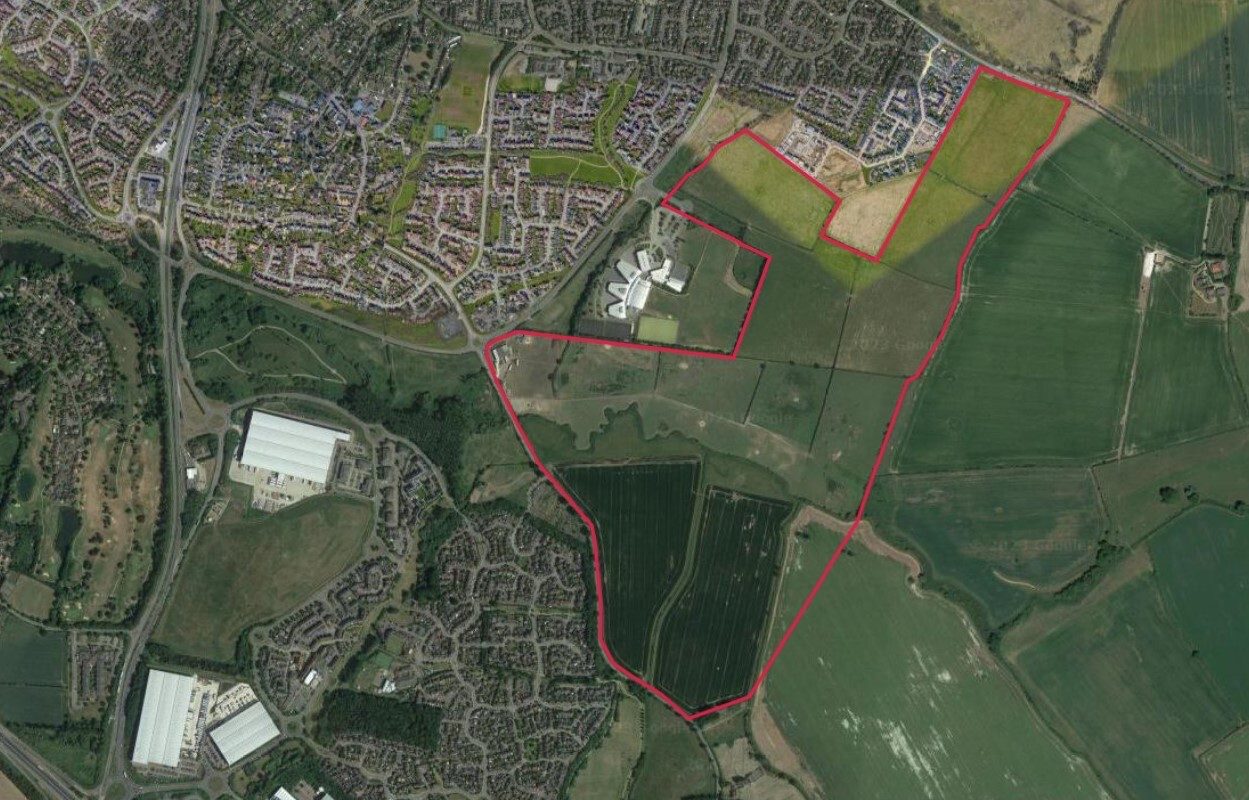 Aerial image of a plot of land, outlined in red.