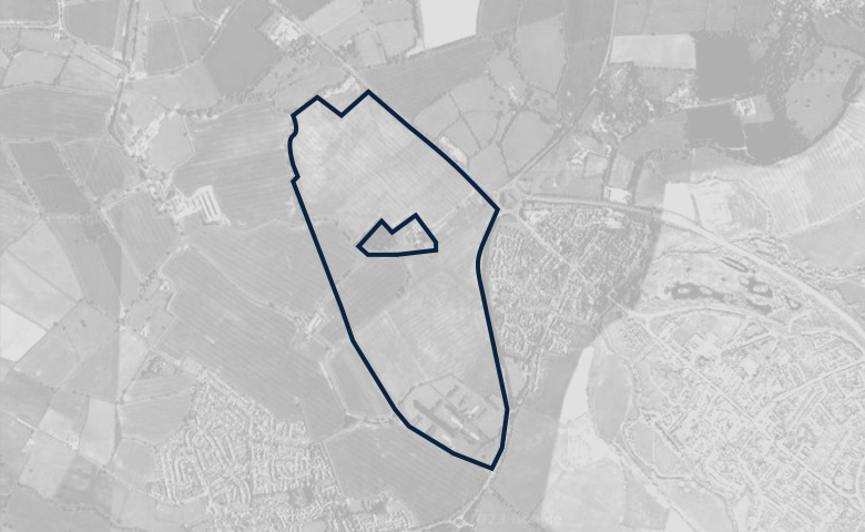Greyscale aerial image of a plot of land, outlined in dark blue.